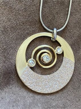 Gold- Two Tone Spiral Pendant Necklace with Crystal Accents looks like CZ’s